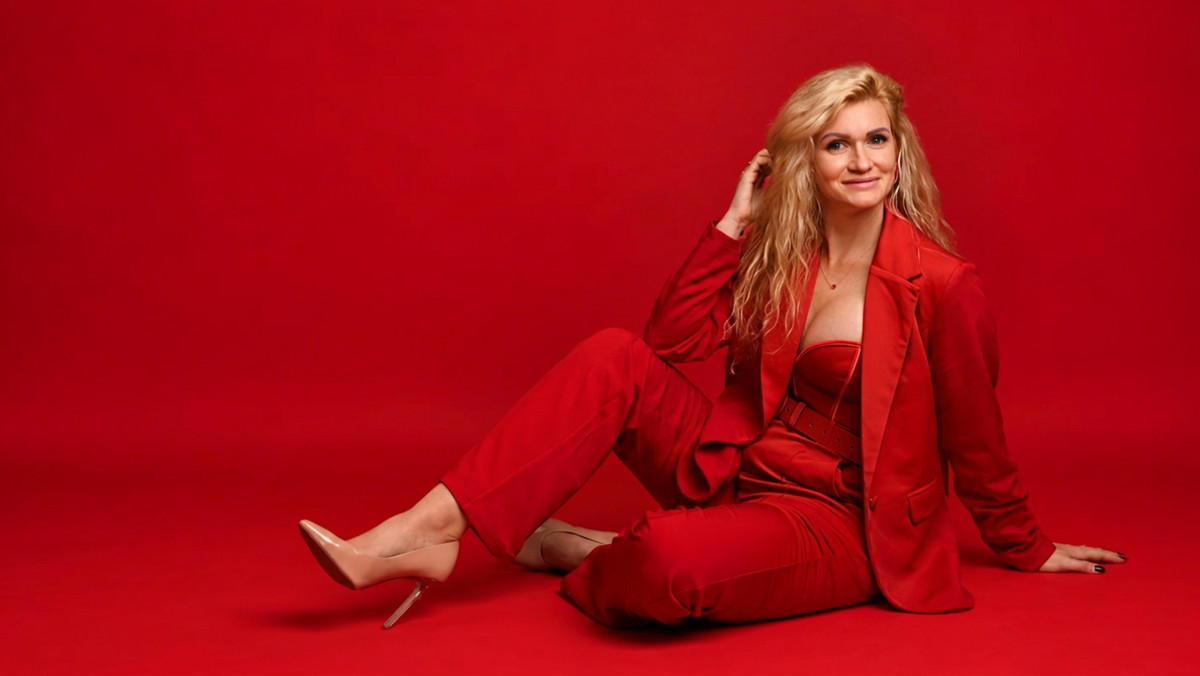 Red Gamso seated in a red suit