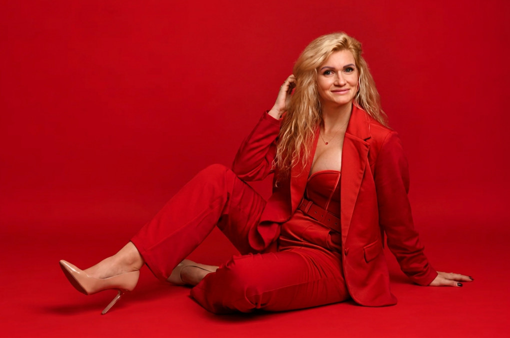 Red Gamso seated in a red suit